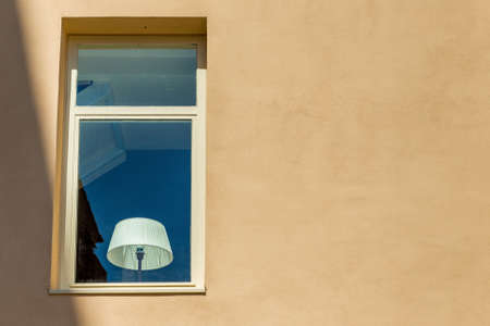 white lampshade behind a window