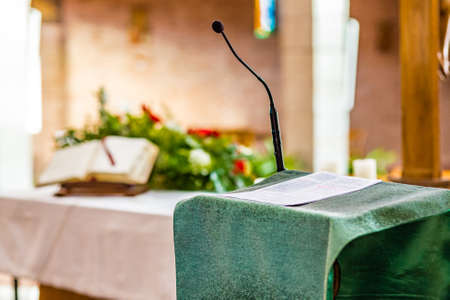 Pages of Gospel book on the concrete pulpit ready to be readの写真素材