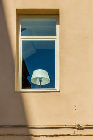white lampshade behind a window