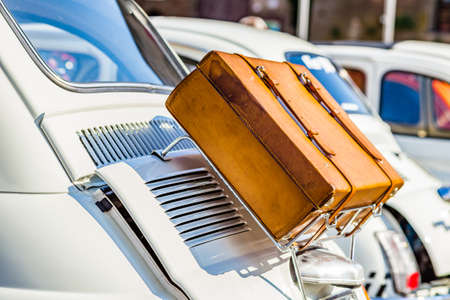 leather suitcase on luggage rack of ancient Italian subcompact white carのeditorial素材
