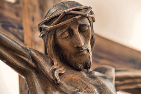 the face of Jesus crucified on the cross in a wooden statueの写真素材