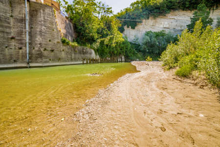 the clear and transparent waters on the bed of a river on the green hills of Emilia Romagna in Italyの写真素材