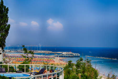 spectacular and colorful view of the beaches of the Marche region in Italy papered by umbrellas in rows in seaside resortsの写真素材
