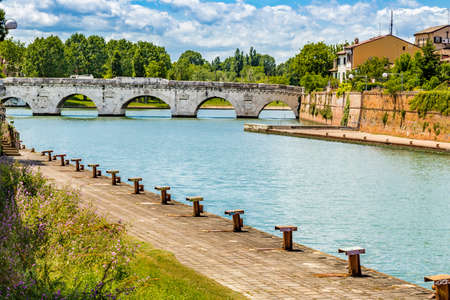 clear water under the arches of the Roman bridge of Augustusの写真素材