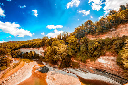 the clear and transparent waters on the bed of a river on the green hills of Emilia Romagna in Italy