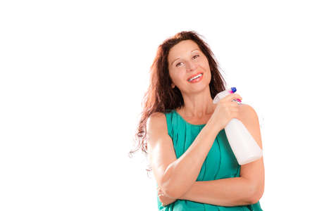 mature lady holds a detergent sprayer keeping the same pose of a secret agent holding a gunの写真素材