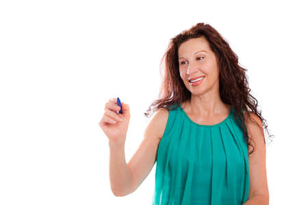 Handsome mature lady woman with pen writing in the air as on imaginary panel isolated on whiteの写真素材