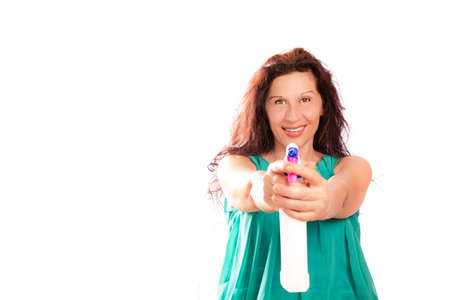 mature lady holds a detergent sprayer keeping the same pose of a secret agent holding a gunの写真素材