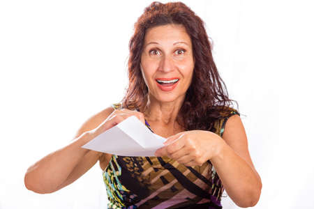 Happy mature woman with wrinkles and aging skin opening white envelopesの写真素材