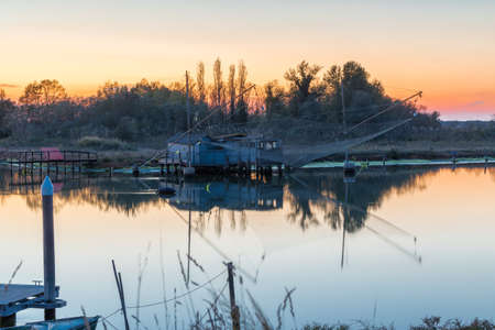 blue hour on fishing house in lagoon in Italy