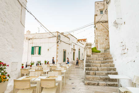 Table, cushions and chairs in a street in Ostuni, The White Cityの写真素材