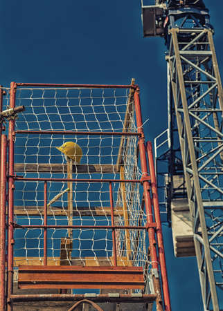 Protective yellow helmet left on scaffolding