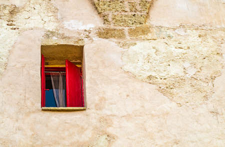 red shutters window on grunge wallの写真素材