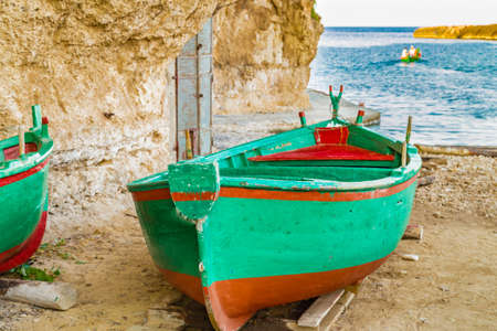 Green rowing boats aground on the beachの写真素材