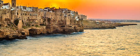 the houses perched on the promontory of a seaside town in southern italyの写真素材