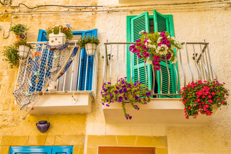flowers on the balconies of houses in ancient village in southern Italyの写真素材