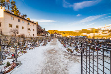 the snowy cemetery of an alpine village in Italyの写真素材