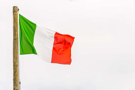 Italian flag waving on wooden poleの写真素材