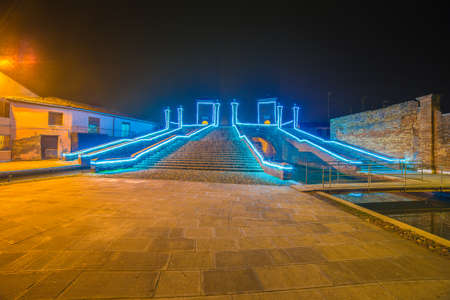 Christmas lights on ancient bridge in Italyの写真素材