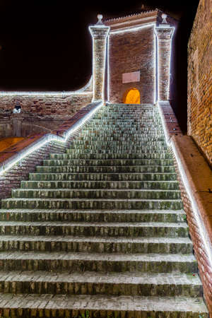 ancient bridge at night lit by Christmas lights in Comacchio, the Little Venice, in Italyの写真素材