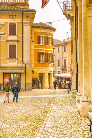 colorful houses on street of Italian town with weekly marketの写真素材