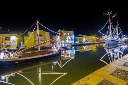 night view of Christmas Lights and decorations and marine crib, a Christmas Nativity scene on floating boats, in Italyの写真素材