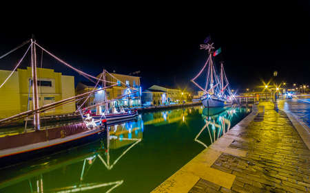 night view of Christmas Lights and decorations and marine crib, a Christmas Nativity scene on floating boats, in Italyの写真素材