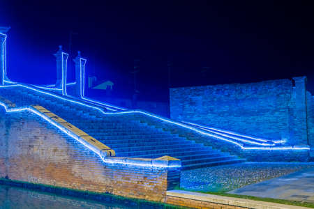 Christmas lights on ancient bridge in Italyの写真素材