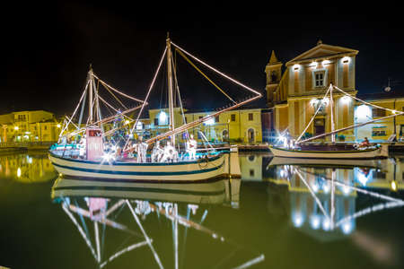 night view of Christmas Lights and decorations and marine crib, a Christmas Nativity scene on floating boats, in Italyの写真素材