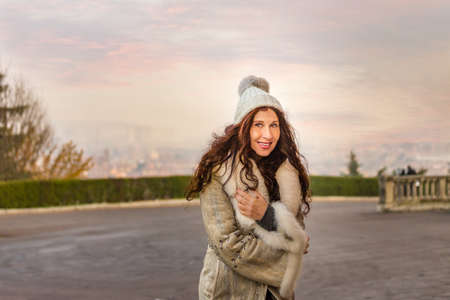 attractive menopausal woman walking in city  in winter clothingの写真素材