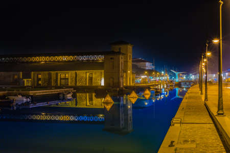 decorations and holiday lights  on canal harbor in an Italian villageの写真素材