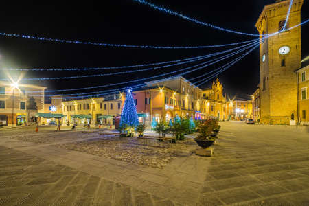 Christmas decorations and holiday lights in the main square of an Italian medieval villageの写真素材