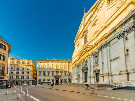 two nuns in front of the baroque facade of Church of the Most Holy Name of Jesus in winter in Romeの写真素材