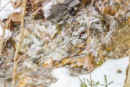 detail of snowy mountain streamの写真素材