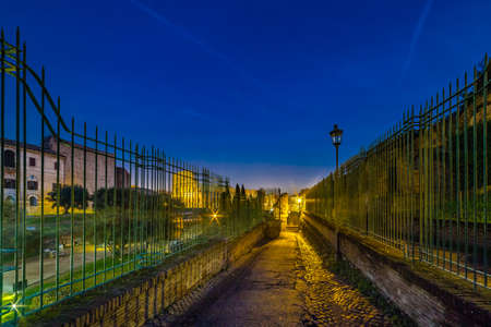 Night view of road to Arch of Constantine and Colosseum or Coliseum in Rome, Italyの写真素材
