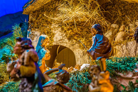 blurred shepherds with sheep coming to adore Baby Jesus in a Christmas Nativity sceneの写真素材
