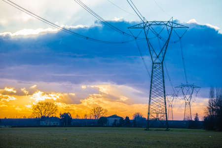 Winter sunrise on high voltage pylons in the countryside in Italy