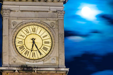 ancient clock tower at nightの写真素材