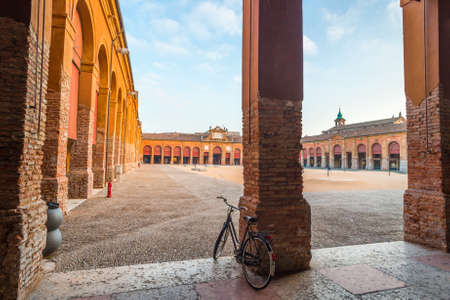 bicycle and ancient arcade in Italy at sunsetの写真素材