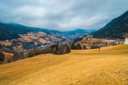 typical mountain village in alpine valley in Italyの写真素材