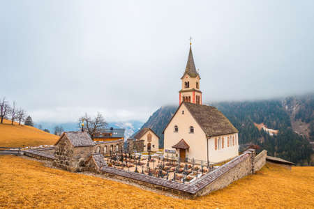 cemetery in the snow on the Dolomite Alps in Italyの写真素材
