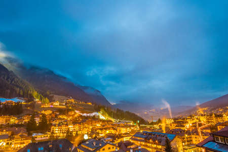 night view of typical mountain village in alpine valley in Italyの写真素材