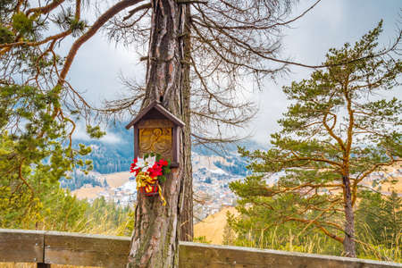Nativity scene overlooking mountain village in alpine valley in Italyの写真素材