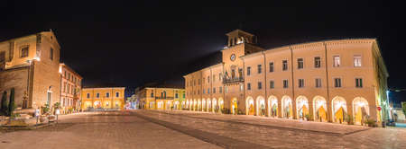 Church and town hall in the central square of a village in northern Italy at nightの写真素材