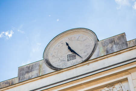 ancient clock on white buildingの写真素材