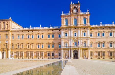 mirror of water of fountains in front of baroque Royal Palace in Modena, Italyの写真素材