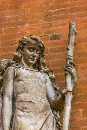 statue of angel holding stickのeditorial素材