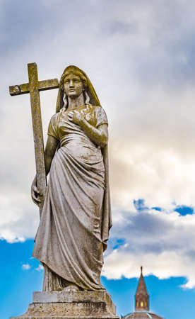 statue of woman holding The Holy Crossのeditorial素材