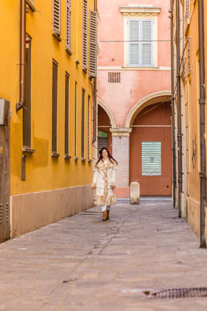 Elegant middle-aged woman walking on the streets of Modena in Italyの写真素材