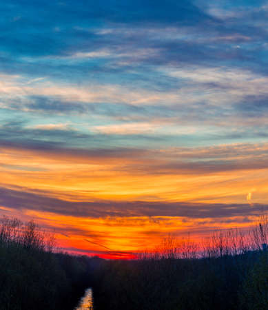 winter sunset on a country river in the northern hemisphereの写真素材